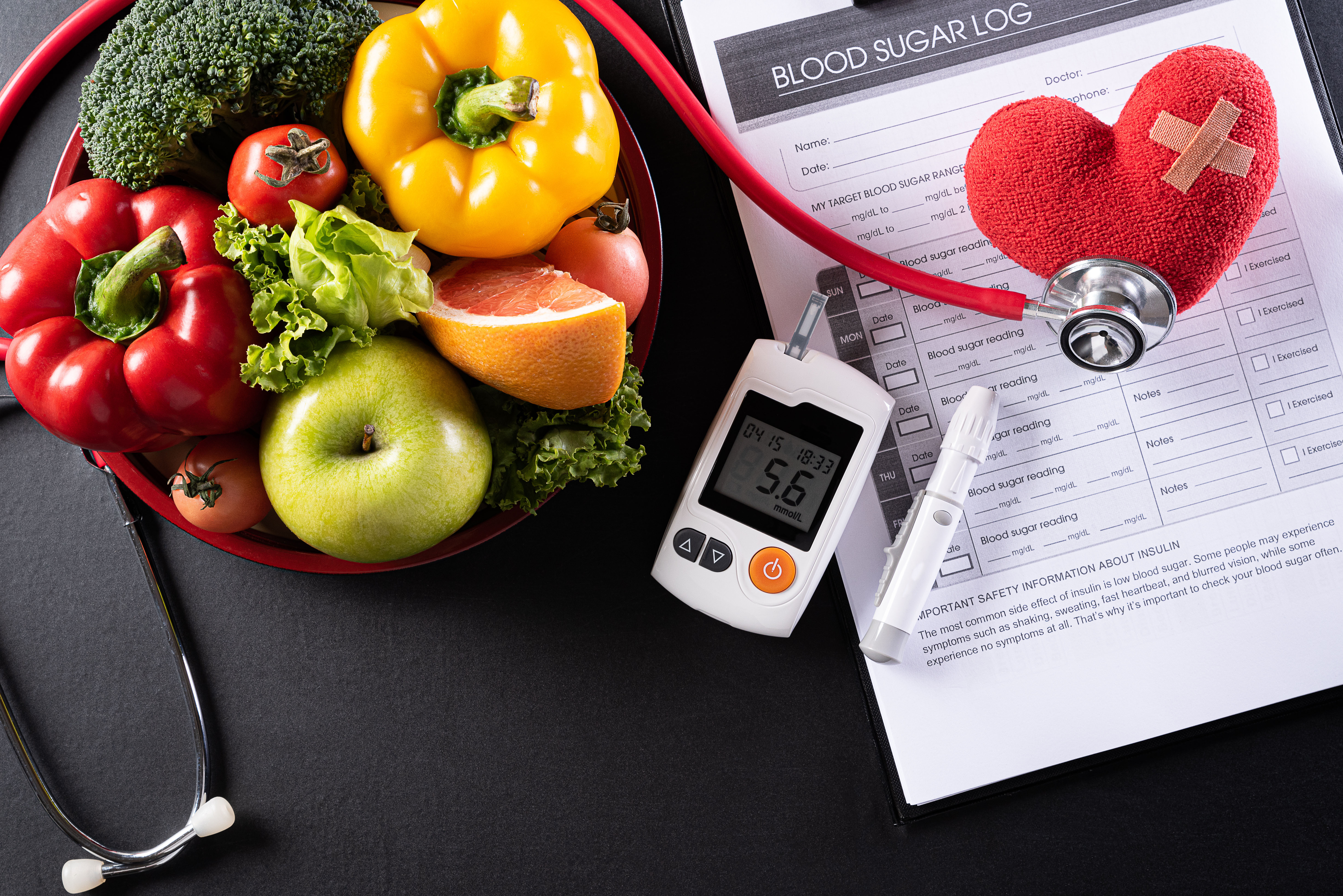 Fruits, vegetables, and a blood sugar monitor