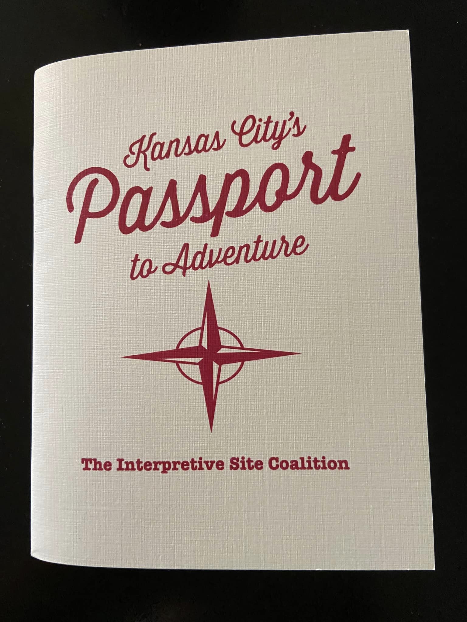 Passport book that says "Kansas City Passport to Adventure". It is sponsored by the interpretive site coalition. 