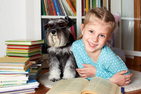 Little girl with dog and books