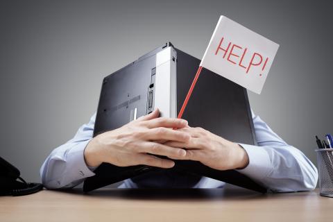 Man holding a laptop and help sign