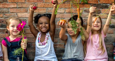 Children with produce from garden