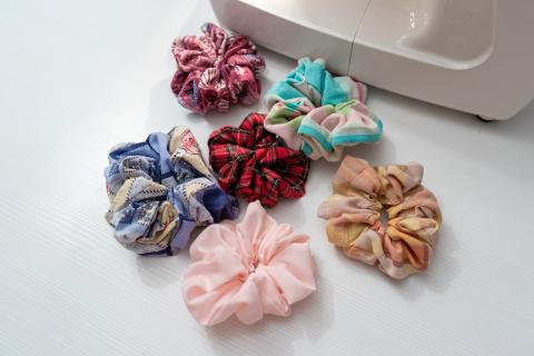 Scrunchies of different colors on white table.
