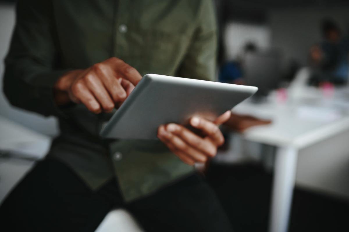 Black man holding a tablet