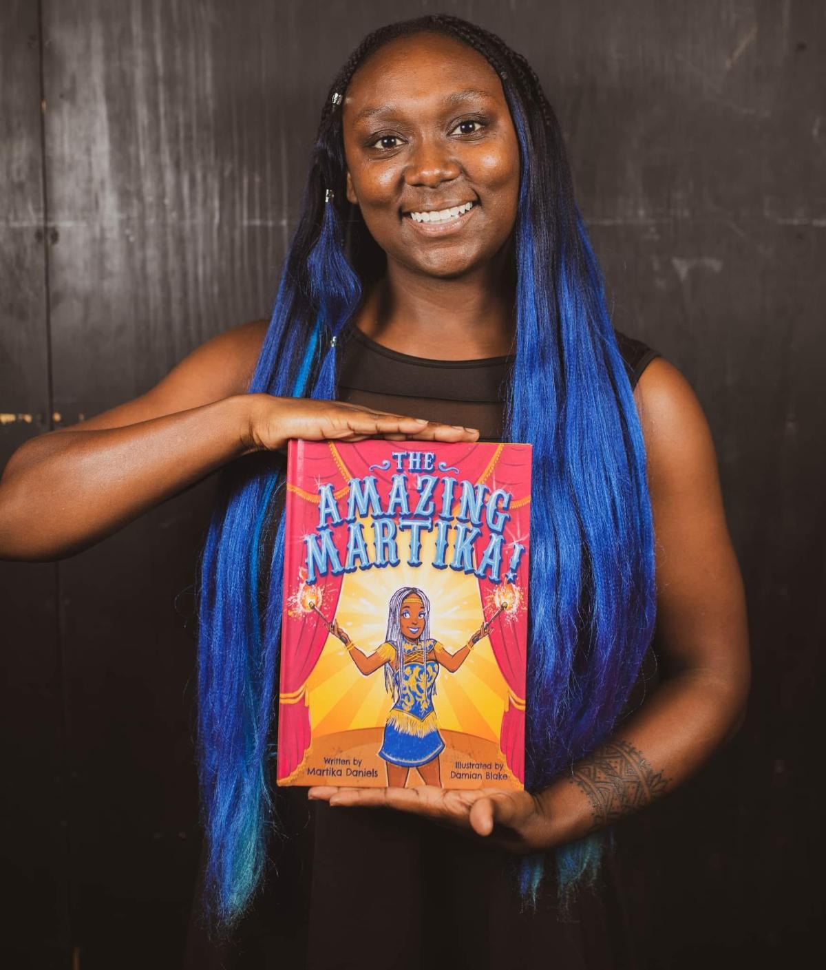 Martika Daniels with her Book