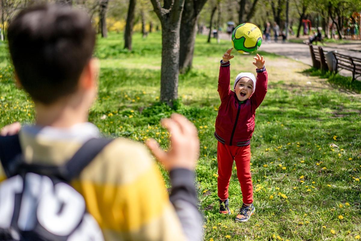 Children throwing a soccer ball back and forth